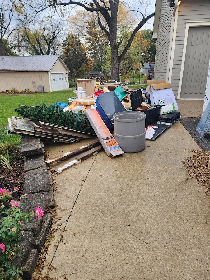 Dumpster being loaded with debris for Estate Cleanout Dumpster Rental in Conway